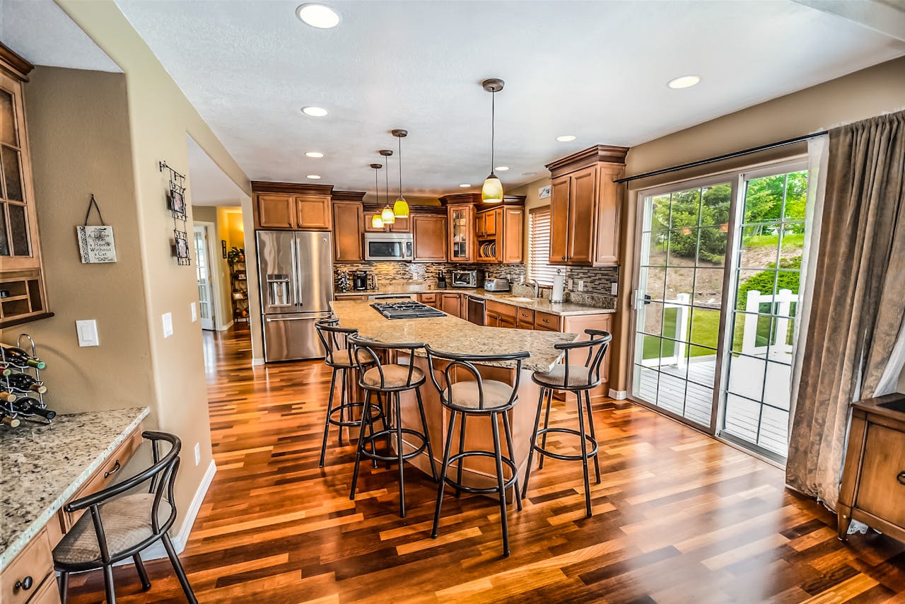 contact-hero-img A luxurious modern kitchen featuring hardwood floors and granite countertops.